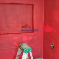 Applying RedGard waterproofing membrane to a tiled shower wall in progress in Chelmsford, MA. This crucial step ensures long-lasting moisture protection before tile installation. Bathroom Remodeling Contractor in Chelmsford MA