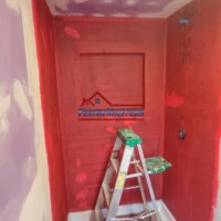 Applying RedGard waterproofing membrane to a tiled shower wall in progress in Chelmsford, MA. This crucial step ensures long-lasting moisture protection before tile installation. Bathroom Remodeling Contractor in Chelmsford MA