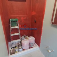 Applying RedGard waterproofing membrane to a tiled shower wall in progress in Chelmsford, MA. This crucial step ensures long-lasting moisture protection before tile installation. Bathroom Remodeling Contractor in Chelmsford MA