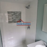 Bathroom renovation with new shower and vanity by Finish Masters Construction & Painting. Modern bathroom with shower and vanity, completed by Finish Masters Construction & Painting.