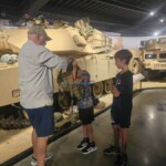 Visitors exploring military tanks at the Finish Masters Construction & Painting exhibit. Tank display at Finish Masters Construction & Painting exhibit.