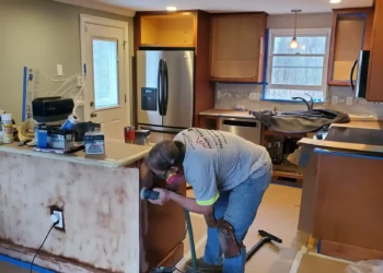 Quality finishes begin with proper preparation. One of our skilled finishers carefully sands each cabinet component while J.R. Ross oversees the project to ensure every detail meets our standards.
<p>
See how Finish Masters transformed this kitchen during our
<a rel="noopener"
href="https://myfinishmasters.com/cabinet-painting-tewksbury-ma/"
style="color:#0073aa; font-weight:700;">
Cabinet Painting Tewksbury MA Project
</a>
using our professional cabinet painting process and durable furniture-grade coatings.
</p> Finish Masters cabinet refinishing project in Tewksbury Massachusetts showing a skilled finisher sanding kitchen cabinets while J.R. Ross oversees quality control and surface preparation.