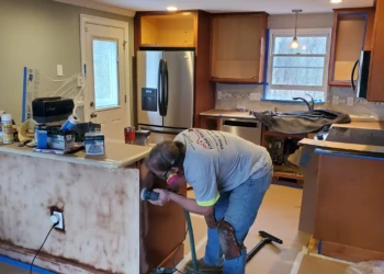 Quality finishes begin with proper preparation. One of our skilled finishers carefully sands each cabinet component while J.R. Ross oversees the project to ensure every detail meets our standards.
<p>
See how Finish Masters transformed this kitchen during our
<a rel="noopener"
href="https://myfinishmasters.com/cabinet-painting-tewksbury-ma/"
style="color:#0073aa; font-weight:700;">
Cabinet Painting Tewksbury MA Project
</a>
using our professional cabinet painting process and durable furniture-grade coatings.
</p> Finish Masters cabinet refinishing project in Tewksbury Massachusetts showing a skilled finisher sanding kitchen cabinets while J.R. Ross oversees quality control and surface preparation.