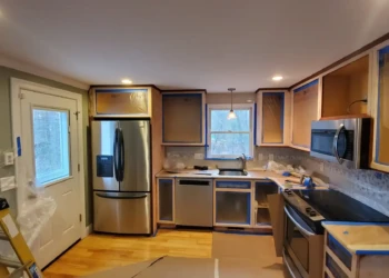 Finish Masters team installing new kitchen cabinets and appliances for a complete home upgrade. Kitchen renovation with new cabinets, appliances, and countertops.
