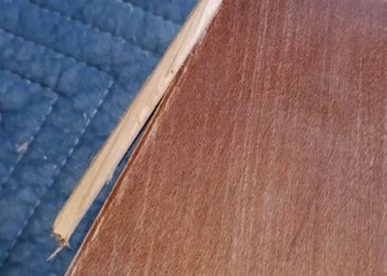 Many contractors would recommend replacing this damaged drawer front. At Finish Masters, we have the skills to restore it, preserving the original cabinetry while creating a seamless repair ready for cabinet painting. Finish Masters cabinet painting project in Tewksbury Massachusetts showing a broken cabinet drawer front being professionally repaired before sanding, priming, and painting.