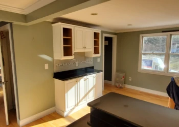 A different angle, the same commitment to quality. Every cabinet, door, drawer front, and finish detail reflects the craftsmanship that Finish Masters proudly stands behind with our name, reputation, and written warranty. Finish Masters cabinet refinishing project in Tewksbury Massachusetts showing completed coffee bar cabinets with doors and drawer fronts installed as part of our reputation-backed better-than-factory finishing process.