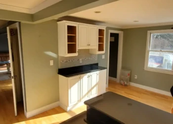 Beautiful results don't happen by accident. Every door, drawer front, and cabinet surface reflects the craftsmanship, preparation, and attention to detail that Finish Masters proudly stands behind with our name and reputation. Finish Masters cabinet refinishing project in Tewksbury Massachusetts showing the completed coffee bar area with refinished cabinet doors and drawer fronts installed as part of our reputation-backed better-than-factory finishing process.