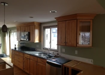 Kitchen cabinets being refinished in a home kitchen.