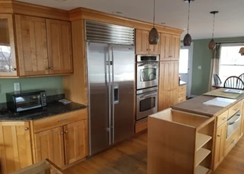 Kitchen cabinets being refinished with natural wood finish in Nahant MA.