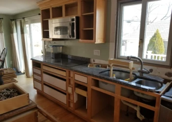 Kitchen cabinets being refinished with new paint and finish in Nahant MA.
