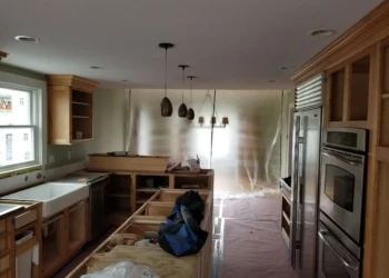 Kitchen cabinets being refinished in a home renovation project.