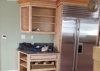 Refinished kitchen cabinets with new paint and hardware in Nahant MA.