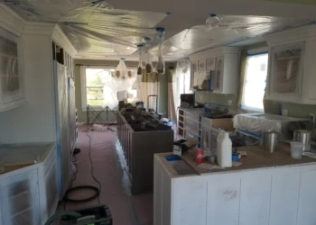 Kitchen cabinets being refinished and painted in a home in Nahant MA.