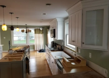 Kitchen cabinets being refinished in a home renovation project.