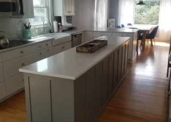 Kitchen cabinets being refinished with a smooth, painted finish in Nahant MA.