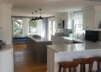 Kitchen cabinets being refinished in a modern kitchen setting.
