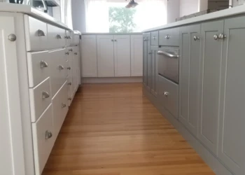 Kitchen cabinets being refinished with a fresh coat of paint.