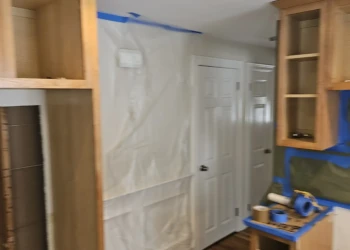 The best cabinet painting projects begin with protecting the home. Dust barriers, masking, and containment systems are installed before sanding begins to ensure a cleaner process and a better finished product. Finish Masters cabinet painting project in Burlington Massachusetts showing dust containment barriers, masking, and cabinet preparation before painting in Benjamin Moore AF-70 Storm.