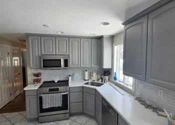 From dated orange-toned cabinetry to a timeless designer finish. These cabinets were professionally painted in Benjamin Moore AF-70 Storm, transforming the kitchen while showcasing the craftsmanship, attention to detail, and accountability that define the Finish Masters name. Finish Masters cabinet painting project in Burlington Massachusetts showing completed kitchen cabinets painted Benjamin Moore AF-70 Storm with a furniture-grade finish backed by our name, reputation, and written warranty.