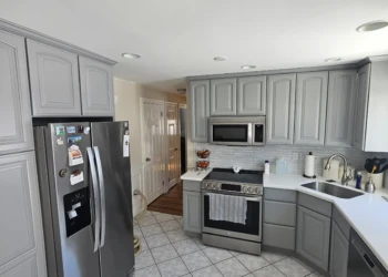 A complete kitchen transformation without the cost of cabinet replacement. Professionally painted in Benjamin Moore AF-70 Storm, these cabinets now provide a timeless designer appearance backed by the Finish Masters name, reputation, and written warranty. Finish Masters cabinet painting project in Burlington Massachusetts showing completed kitchen cabinets painted Benjamin Moore AF-70 Storm with a furniture-grade finish backed by our name, reputation, and written warranty.