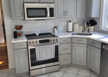 This is the Finish Masters difference. A dated maple kitchen transformed into a bright, modern space through meticulous preparation, professional spray finishes, and a commitment to craftsmanship backed by our name, reputation, and written warranty. Finish Masters cabinet painting project in Burlington Massachusetts showing completed kitchen cabinets painted Benjamin Moore AF-70 Storm with a smooth furniture-grade finish, professional spray application, and warranty-backed craftsmanship.