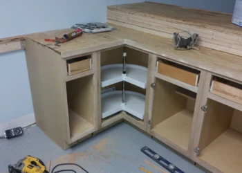 Basement kitchen cabinets with corner lazy Susan shelves and plywood countertop base in Billerica MA