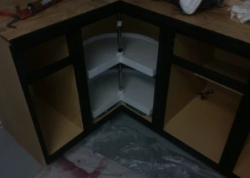 Open black painted oak cabinets with corner shelving in a basement kitchen renovation in Billerica MA