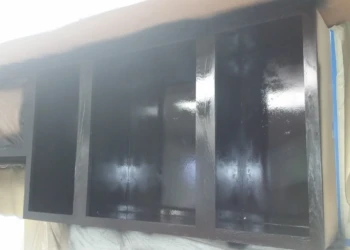Glossy black painted oak kitchen cabinets being refinished in a basement kitchen in Billerica MA