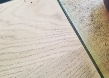 Close-up view of an oak cabinet wood surface being sanded during cabinet refinishing work in Billerica MA