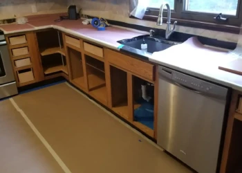 Kitchen cabinets in a Billerica home with doors and drawers removed during cabinet refinishing preparation