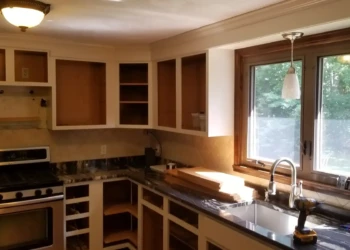 Unfinished kitchen cabinets and drawers removed during refinishing in a Billerica MA home kitchen