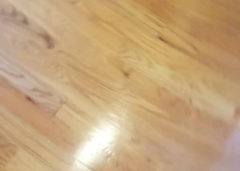 Close-up of refashioned hardwood floor with smooth, polished finish in Billerica home