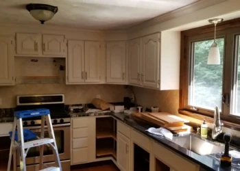 Kitchen with off-white painted cabinets undergoing cabinet painting in Billerica MA