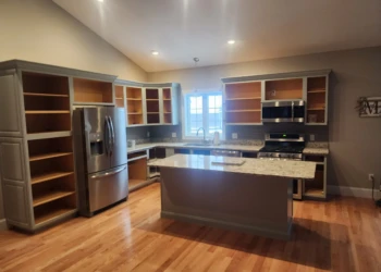 Kitchen cabinets without doors revealing unfinished interiors during cabinet painting in North Andover MA
