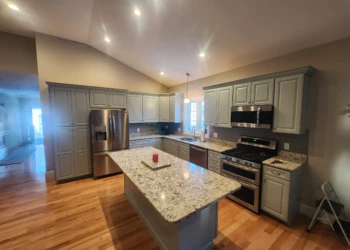 Kitchen featuring gray refinished cabinets with a large granite island and stainless steel appliances in North Andover MA