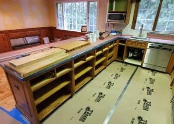 Stripped wooden kitchen cabinets without doors or drawers in Bedford NH kitchen during cabinet refinishing preparation