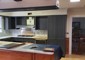 Kitchen with dark grey refinished cabinets, white marble countertops, and wood flooring in Bedford, NH kitchen remodeling project
