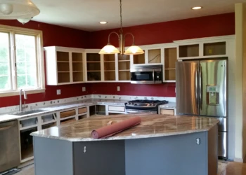 Kitchen with refinished cabinets and island surfaces during a cabinet refinishing project in Carlisle MA