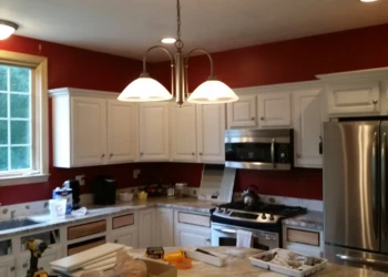 White kitchen cabinets with some cabinet doors removed in the process of refinishing in a Carlisle MA kitchen