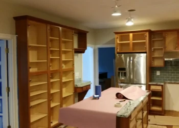 Close-up of kitchen cabinets being refinished in Concord MA, showing sanding and preparation for new.