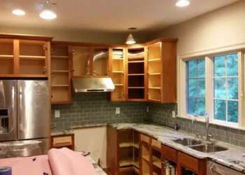 Refinished kitchen cabinets in Concord MA, showing a smooth, polished surface and updated hardware.