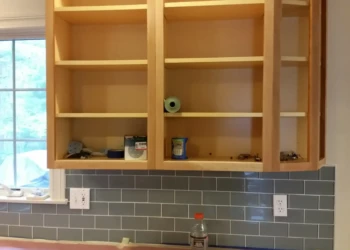 Close-up of unfinished wooden cabinets being refinished in Concord MA kitchen.