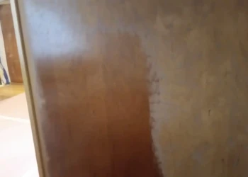 Close-up of a cabinet being refinished in Concord MA, showing the sanding and preparation process.