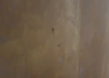 Close-up of a cabinet being refinished in Concord, MA, showing sanding and preparation for painting.