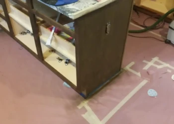 Refinishing cabinet frame in Concord MA, showing sanding and preparation process.