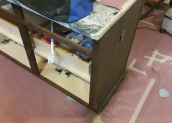 Close-up of a cabinet being refinished in Concord MA, showing sanding and preparation for painting.