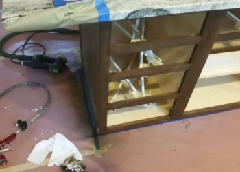 Close-up of a cabinet being refinished with sanding tools in Concord, MA.