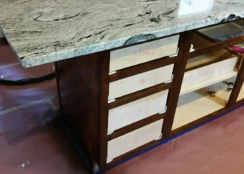 Kitchen cabinets being sanded and prepared for refinishing.