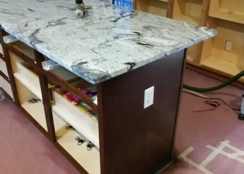 Granite countertop being refinished in a professional kitchen setting.