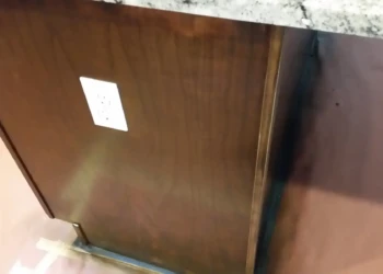 Close-up of a cabinet being refinished with a smooth, polished surface.
